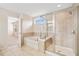 Bathroom features soaking tub, glass shower, and tile floor at 522 Spring View Dr, Woodstock, GA 30188