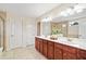 Bathroom features double vanity with wood cabinets and large mirror at 522 Spring View Dr, Woodstock, GA 30188