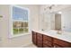 Bathroom vanity has wood cabinets and double sinks at 522 Spring View Dr, Woodstock, GA 30188