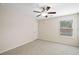 Bedroom features neutral walls, carpet, ceiling fan, and window at 522 Spring View Dr, Woodstock, GA 30188