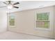 Spacious bedroom with carpet, a ceiling fan, and a window offering a pleasant view at 522 Spring View Dr, Woodstock, GA 30188