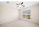 Inviting carpeted bedroom with ceiling fan and window overlooking the neighborhood at 522 Spring View Dr, Woodstock, GA 30188