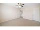 Carpeted bedroom featuring ceiling fan, two doors, and view into hallway at 522 Spring View Dr, Woodstock, GA 30188