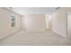 Versatile bonus room with neutral paint, carpet flooring, a window and access to other rooms at 522 Spring View Dr, Woodstock, GA 30188