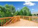 Spacious wooden deck offering a relaxing outdoor space surrounded by lush green trees and blue skies at 522 Spring View Dr, Woodstock, GA 30188