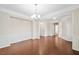 Formal dining area featuring wainscoting, chandelier lighting, and easy access to other living areas at 522 Spring View Dr, Woodstock, GA 30188