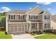 Two-story home with brick and siding, manicured lawn, and two car garage at 522 Spring View Dr, Woodstock, GA 30188