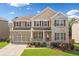Traditional two-story home featuring a well-manicured lawn, brick accents, and charming curb appeal at 522 Spring View Dr, Woodstock, GA 30188