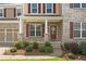 Charming front entrance with manicured landscaping, a covered porch, and brick detailing at 522 Spring View Dr, Woodstock, GA 30188