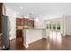 Modern kitchen with stainless steel appliances, granite countertops, dark wood cabinetry, and open layout at 522 Spring View Dr, Woodstock, GA 30188