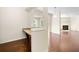 Open living area with a built-in desk space with granite counter, flowing into the living room at 522 Spring View Dr, Woodstock, GA 30188