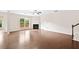 Open living room featuring a fireplace, hardwood floors, and staircase at 522 Spring View Dr, Woodstock, GA 30188
