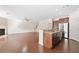 Open-concept living area featuring hardwood floors, a fireplace, and a seamless transition to the kitchen at 522 Spring View Dr, Woodstock, GA 30188