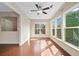 Bright sunroom with hardwood flooring, large windows offering views of the outdoors, and a ceiling fan at 522 Spring View Dr, Woodstock, GA 30188