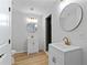 The bathroom features two vanities with white cabinets, gold fixtures, and modern lighting at 2023 Stoneleigh Dr, Stone Mountain, GA 30087