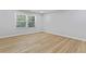 Bright and airy bedroom featuring hardwood floors and a large window, providing ample natural light at 2023 Stoneleigh Dr, Stone Mountain, GA 30087
