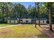 Inviting single Gathering home with spacious front yard and lush, mature trees offering shade and privacy at 2023 Stoneleigh Dr, Stone Mountain, GA 30087