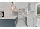 Spacious kitchen featuring a large island, stainless steel appliances, and elegant pendant lighting at 2023 Stoneleigh Dr, Stone Mountain, GA 30087