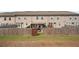 A view of the backyard showing the fence, patio, and the rear of the house at 2404 Fitts Dr, Conyers, GA 30094