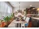 Stylish dining area features an eclectic chandelier, a bench, and decor at 2404 Fitts Dr, Conyers, GA 30094