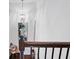 Upstairs hallway featuring chandelier lighting and stylish decor at 2404 Fitts Dr, Conyers, GA 30094