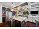An open concept kitchen features stainless appliances, an island, and hardwood flooring at 2404 Fitts Dr, Conyers, GA 30094
