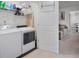 Practical laundry room with washer, dryer, and storage shelving at 2404 Fitts Dr, Conyers, GA 30094