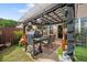 Cozy outdoor patio area with a pergola, dining table, and grill, perfect for entertaining at 2404 Fitts Dr, Conyers, GA 30094