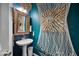 Stylish powder room featuring a pedestal sink and unique nautical wall decor at 2404 Fitts Dr, Conyers, GA 30094