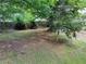Spacious backyard featuring mature trees and a partially wooded area at 3587 Plum Creek Nw Trl, Kennesaw, GA 30152