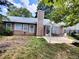 Exterior view of backyard featuring a patio with seating and greenery at 3587 Plum Creek Nw Trl, Kennesaw, GA 30152