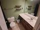 Bathroom features a toilet, vanity, and mirror on the green painted walls at 3587 Plum Creek Nw Trl, Kennesaw, GA 30152
