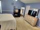 Bedroom featuring a dresser and lighted vanity area and blue walls at 3587 Plum Creek Nw Trl, Kennesaw, GA 30152