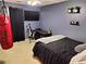 Bedroom with a black bedspread, a ceiling fan, desk, and a mounted television at 3587 Plum Creek Nw Trl, Kennesaw, GA 30152