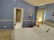 Bedroom featuring an ensuite bath through a doorway and a cross wall decoration at 3587 Plum Creek Nw Trl, Kennesaw, GA 30152