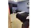 Bedroom with blue walls and a black bedspread and a ceiling fan at 3587 Plum Creek Nw Trl, Kennesaw, GA 30152