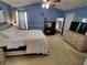A primary bedroom has a bed, dresser, lighted vanity area, and blue walls at 3587 Plum Creek Nw Trl, Kennesaw, GA 30152