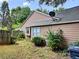 Exterior shot of home with brown siding, a satellite dish, and mature landscaping at 3587 Plum Creek Nw Trl, Kennesaw, GA 30152
