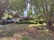 Charming single-story home featuring a brick facade, two-car garage, and a lush, landscaped front yard with mature trees at 3587 Plum Creek Nw Trl, Kennesaw, GA 30152