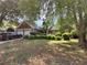 Traditional home featuring a brick facade and two-car garage, surrounded by mature trees at 3587 Plum Creek Nw Trl, Kennesaw, GA 30152