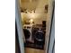 A laundry room featuring a white front load washer and a black front load dryer at 3587 Plum Creek Nw Trl, Kennesaw, GA 30152