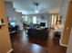 Open-concept living room with a fireplace, ceiling fan, and hardwood floors at 3587 Plum Creek Nw Trl, Kennesaw, GA 30152