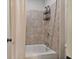 Tiled shower/tub combination with a neutral shower curtain and chrome hardware at 452 Rockford Pass, Marietta, GA 30064