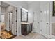 Bathroom vanity with granite countertop, dark cabinetry, and three white doors at 452 Rockford Pass, Marietta, GA 30064