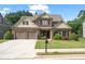Charming two-story home with a well-manicured lawn, brick facade, and a two-car garage on a sunny day at 452 Rockford Pass, Marietta, GA 30064