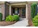 Inviting front porch with brick accents, a seating area, and a decorative front door at 452 Rockford Pass, Marietta, GA 30064