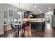 Eat-in kitchen featuring dark cabinets, stainless steel appliances, and hardwood flooring at 452 Rockford Pass, Marietta, GA 30064
