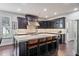 Spacious kitchen island with bar seating, dark cabinetry, and stone countertops at 452 Rockford Pass, Marietta, GA 30064
