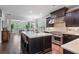 Open concept kitchen with island, bar stools, stainless appliances and view to breakfast nook at 452 Rockford Pass, Marietta, GA 30064