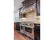 A modern kitchen with a professional range hood and stainless-steel appliances at 452 Rockford Pass, Marietta, GA 30064